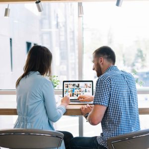 back-view-colleagues-working-laptop-scaled (1)